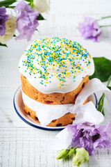 Traditional Easter sweet bread or cakes with white icing and sugar decor and quail eggs over white wooden table. Various Spring Easter cakes. Happy Easter day. Christian traditions.  Top view.