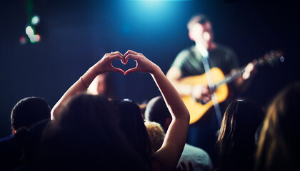 For the love of the music. Cropped shot of an unrecognizable womans hands making a heart shape...