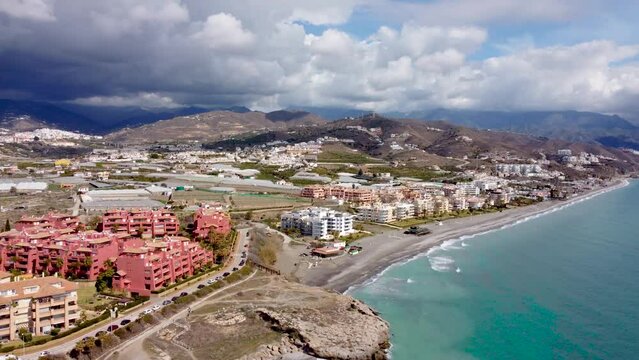 Torrox Costa view from above. Drone footage of this costal city situated in Malaga province, Costa del Sol - Spain. Touristic travel destination. Drone pan left.