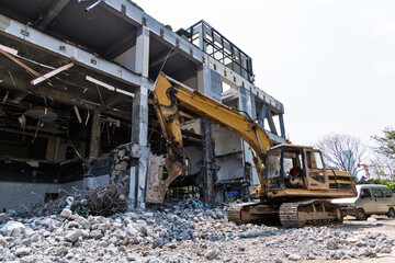 Excavator working on building demolition site