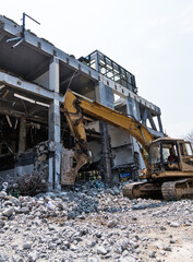 Fototapeta na wymiar Excavator working on building demolition site