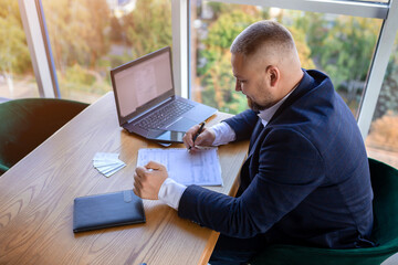 Young happy businessman working in business centre. Work hub concept