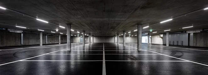 Foto op Canvas Front view of new empty underground parking with concrete columns, shiny asphalt and nobody inside © alexandre zveiger