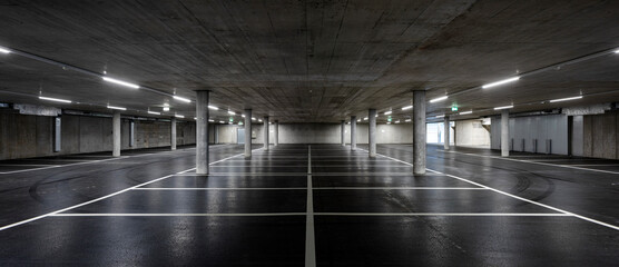 Front view of new empty underground parking with concrete columns, shiny asphalt and nobody inside - obrazy, fototapety, plakaty