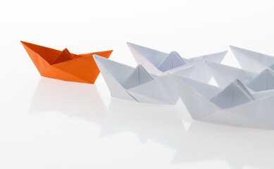 The orange origami boat is leader