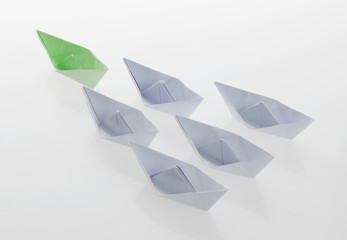The green origami boat is leader