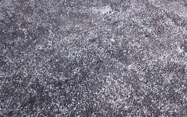 Snow on city asphalt texture backdrop