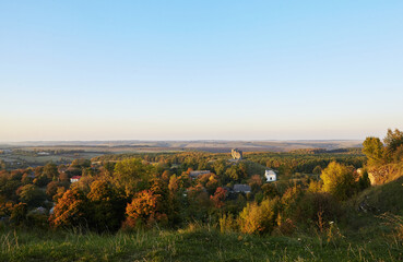 Scenic view on Pidkamin inselberg on adjacent hill and nearby village in Brody region of Galychyna, Ukraine