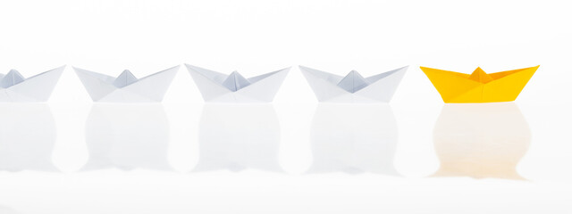 The yellow origami boat is leader