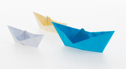 The blue origami boat is leader