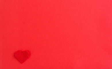 Red origami heart on red background