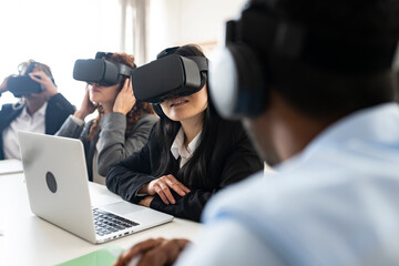 multi-racial, multi-age coworkers use VR glasses concept, business meeting - focus asian woman -