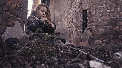 girl praying. Children without a home, apocalypse, war