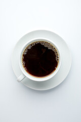 Coffee filter in a white porcelain cup with a saucer on a white background