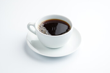 Coffee filter in a white porcelain cup with a saucer on a white background