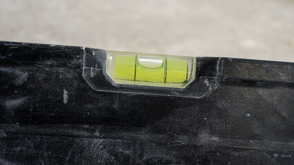Checking floor surface with a bubble level