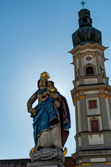 Fototapeta na wymiar Church with fountain in statue in Deggendorf, Bavaria