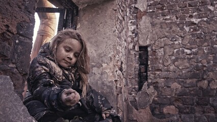 girl praying. Children without a home, apocalypse, war