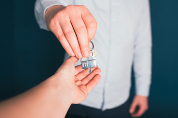 Female hand taking key from realtor buying renting new house, getting real estate ownership concept.