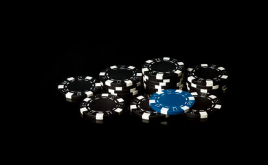 Black chips obtained as a result of winning and one blue. A successful combination in the casino. Luck or fortune in a poker club