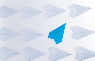 Blue origami plane stand out from the crowd