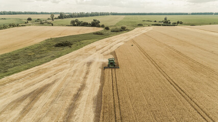Aerial view combine harvester harvesting on the field