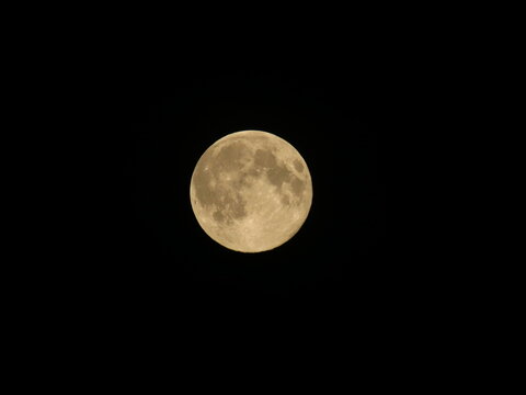Full moon behind a black sky