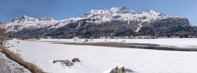 river Inn flowing among snowy plains, Sils, Switzerland