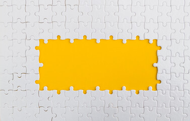 Pieces of jigsaw puzzle on yellow background