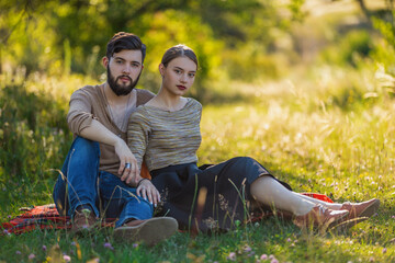 young couple sitting in summer garden