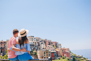 Happy family with view of the old european village in Cinque Terre national park, Liguria, Italy