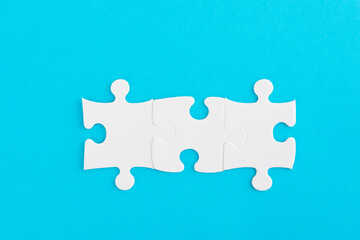 Three puzzle pieces on blue background