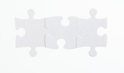 Three puzzle pieces on white background
