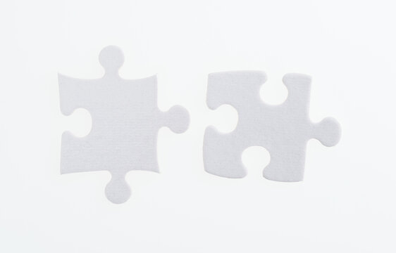 Two Puzzle Pieces On White Background