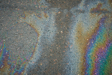Color Gasoline fuel spots on Asphalt Road as Texture or Background. Environmental pollution concept