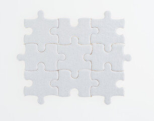 White puzzle pieces on white background
