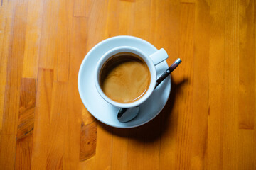 Cup of americano coffee on wooden table.