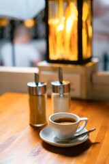 Cup of americano coffee and sugar bowl.