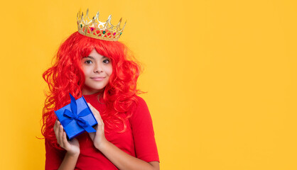child smile in crown with gift box on yellow background