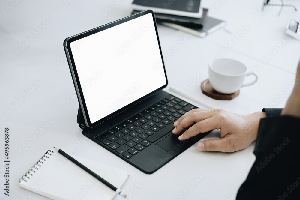 Poster young man using work from home tablet at work, the blank space on the computer screen can insert tex