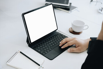 Young man using work from home tablet at work, the blank space on the computer screen can insert text.