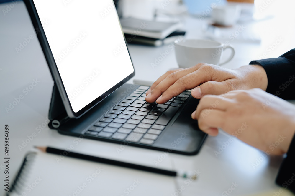 Poster young man using work from home tablet at work, the blank space on the computer screen can insert tex