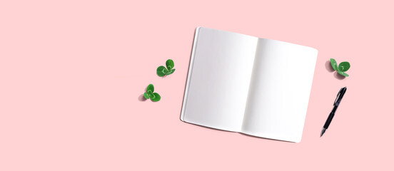 Blank notebook with shamrock leaves - flat lay