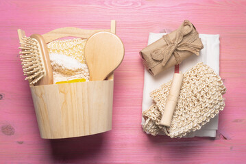 Bath or bath house background. Bathroom accessories on a pink wooden flat lay table.