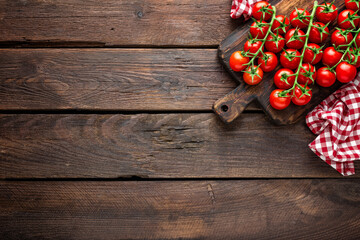 Fototapeta na wymiar Fresh cherry tomatoes on twigs on wooden table, top view