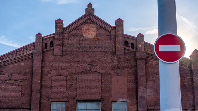 No entry sign in an old town. Red no entry traffic sign on old building background. The road is closed red round sign.