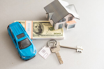 saving money small toy car with house loan concept finance growth and property on gray background...