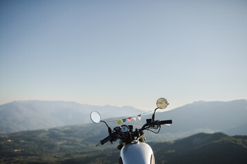 classic motorcycle in the mountains at sunset