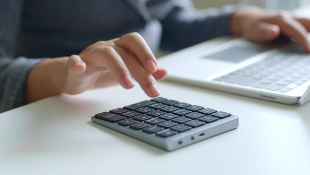 Close up of accountant typing / calculating for investment, budget, income and profit. Finance and accounting concept