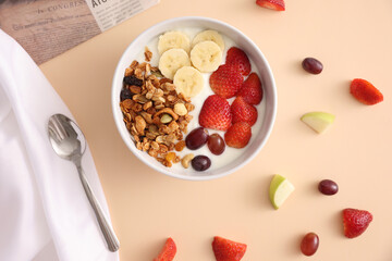 bowl of granola cereal with yogurt and berries isolated on eggnog color background